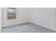 Neutral carpeted bedroom features ample natural light from the window, creating a welcoming space at 19984 W Washington St, Buckeye, AZ 85326