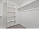Walk-in closet features multiple shelves and hanging rod, providing ample storage space at 19984 W Washington St, Buckeye, AZ 85326