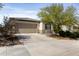 Single-story home featuring desert landscaping, a two-car garage, and a spacious driveway on a sunny day at 19984 W Washington St, Buckeye, AZ 85326