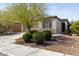Charming single-story home featuring desert landscaping and a well-maintained front yard on a sunny day at 19984 W Washington St, Buckeye, AZ 85326
