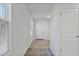 Bright hallway with neutral walls and flooring, leading to the front door and other rooms at 19984 W Washington St, Buckeye, AZ 85326