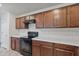 Close-up of kitchen showing an electric range, solid surface countertop, and wood cabinets at 19984 W Washington St, Buckeye, AZ 85326