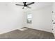 A bright bedroom featuring neutral carpeting, white walls, a ceiling fan, and a window at 20116 W Monroe St, Buckeye, AZ 85326