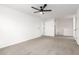 A clean and spacious carpeted bedroom featuring a ceiling fan at 20116 W Monroe St, Buckeye, AZ 85326