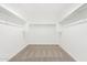 An empty walk-in closet providing ample storage space at 20116 W Monroe St, Buckeye, AZ 85326