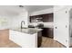 Modern kitchen featuring a granite countertop island and stainless steel appliances at 20116 W Monroe St, Buckeye, AZ 85326