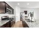 Modern kitchen island featuring stainless steel appliances, granite counters, and a modern faucet at 20116 W Monroe St, Buckeye, AZ 85326