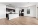 Modern kitchen and breakfast nook with stainless steel appliances, granite counters, and light-colored floors at 20116 W Monroe St, Buckeye, AZ 85326