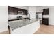 Modern kitchen island featuring stainless steel appliances, granite counters, and a modern faucet at 20116 W Monroe St, Buckeye, AZ 85326