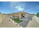 Lush backyard featuring a covered patio, artificial turf, and meticulously kept landscaping at 2101 S Meridian Rd # 146, Apache Junction, AZ 85120
