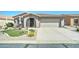 Charming home featuring desert landscaping, a two-car garage, and a welcoming arched entryway and covered porch at 2101 S Meridian Rd # 146, Apache Junction, AZ 85120
