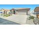 Inviting single-story home featuring a well-manicured front yard with gravel and a two-car attached garage at 2101 S Meridian Rd # 146, Apache Junction, AZ 85120