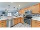Bright kitchen featuring stainless steel appliances, wooden cabinets, stylish countertops, and pendant lighting at 2101 S Meridian Rd # 146, Apache Junction, AZ 85120