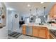 Open-concept kitchen featuring stainless steel appliances, bar seating, and stylish pendant lights at 2101 S Meridian Rd # 146, Apache Junction, AZ 85120