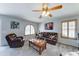 Cozy living room with plush carpeting, a ceiling fan, and plenty of natural light from the large window at 2101 S Meridian Rd # 146, Apache Junction, AZ 85120