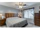 Bedroom featuring a ceiling fan, window with curtains, and matching bedside tables at 2101 S Meridian Rd # 146, Apache Junction, AZ 85120
