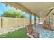 Relaxing covered patio with outdoor seating and views of the green lawn and backyard at 2101 S Meridian Rd # 146, Apache Junction, AZ 85120