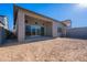 Exterior features a covered patio, large windows, and a spacious backyard at 21436 W Meadowbrook Ave, Buckeye, AZ 85396