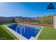 Virtually staged backyard with a pool, grass and mountain views, perfect for outdoor relaxation and entertainment at 21436 W Meadowbrook Ave, Buckeye, AZ 85396