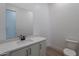 Powder room featuring a white vanity, quartz countertop, modern fixtures, and neutral paint at 21436 W Meadowbrook Ave, Buckeye, AZ 85396