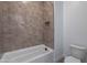 Bathroom featuring a tiled shower and toilet at 21436 W Meadowbrook Ave, Buckeye, AZ 85396