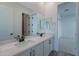 Bathroom featuring a double sink vanity with white cabinets and a large mirror at 21436 W Meadowbrook Ave, Buckeye, AZ 85396