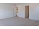 Neutral bedroom features plush carpet and white trim, offering a serene and inviting atmosphere at 21436 W Meadowbrook Ave, Buckeye, AZ 85396