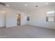 Expansive primary bedroom boasts neutral carpet, recessed lighting, and abundant natural light at 21436 W Meadowbrook Ave, Buckeye, AZ 85396