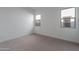 Bedroom with neutral walls, carpet, and two windows at 21436 W Meadowbrook Ave, Buckeye, AZ 85396