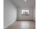 Bright bedroom boasts light wood floors and natural light from a large window at 21436 W Meadowbrook Ave, Buckeye, AZ 85396