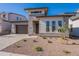 Charming single-Gathering home with a desert landscape and modern architecture, featuring a stone driveway at 21436 W Meadowbrook Ave, Buckeye, AZ 85396