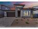 Charming single-Gathering home with a desert landscape and modern architecture, featuring a stone driveway at 21436 W Meadowbrook Ave, Buckeye, AZ 85396