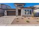 Charming single-Gathering home with a desert landscape and modern architecture, featuring a stone driveway at 21436 W Meadowbrook Ave, Buckeye, AZ 85396