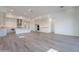 Spacious open floorplan featuring an island kitchen, stainless steel appliances, and wood flooring at 21436 W Meadowbrook Ave, Buckeye, AZ 85396