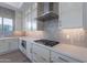 Modern kitchen featuring white cabinets, stainless steel appliances, a gas cooktop, and subway tile backsplash at 21436 W Meadowbrook Ave, Buckeye, AZ 85396