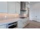 Modern kitchen featuring white cabinets, stainless steel appliances, a gas cooktop, and subway tile backsplash at 21436 W Meadowbrook Ave, Buckeye, AZ 85396