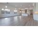 A bright and open living room with large windows, offering lots of natural light and wood flooring at 21436 W Meadowbrook Ave, Buckeye, AZ 85396