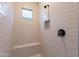 Tiled walk-in shower features a shower bench, recessed lighting, and modern fixtures at 21436 W Meadowbrook Ave, Buckeye, AZ 85396