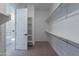 Walk-in closet is complete with ample storage, closet rods and shelving, and neutral carpet at 21436 W Meadowbrook Ave, Buckeye, AZ 85396