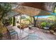 Spacious backyard featuring a covered patio, lush greenery, and ample seating, perfect for outdoor gatherings at 2217 W Claremont St, Phoenix, AZ 85015