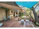 Inviting backyard featuring shaded seating area and lush landscaping creating a serene outdoor living space at 2217 W Claremont St, Phoenix, AZ 85015