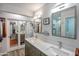 Modern bathroom featuring double sinks, large mirrors, and a glass-enclosed shower, perfect for morning routines at 2217 W Claremont St, Phoenix, AZ 85015