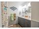 Stylish bathroom with a double vanity, gray cabinets, decorative mirrors, and a charming, themed shower curtain at 2217 W Claremont St, Phoenix, AZ 85015