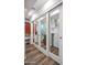 Bright hallway features open closet space, a washer-dryer, and a view into the bathroom and shower at 2217 W Claremont St, Phoenix, AZ 85015