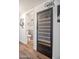 Home interior featuring a wine refrigerator and a glimpse into the half bathroom; perfect for entertaining guests at 2217 W Claremont St, Phoenix, AZ 85015