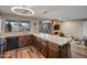 Well-lit kitchen features a large island, wood cabinets, and stainless steel dishwasher for modern convenience at 2217 W Claremont St, Phoenix, AZ 85015