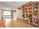 Versatile living area with built-in shelving, a full-length mirror, and cork flooring, offering a bright and open space at 2217 W Claremont St, Phoenix, AZ 85015