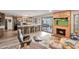 Open-concept living room with a fireplace and a view of the kitchen and outdoor patio at 2217 W Claremont St, Phoenix, AZ 85015