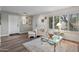 Cozy living room featuring hardwood floors, a comfortable armchair, and lots of natural light at 2217 W Claremont St, Phoenix, AZ 85015