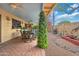 Charming covered patio featuring ample seating and dining options, with a well-manicured stone and gravel landscape at 2217 W Claremont St, Phoenix, AZ 85015